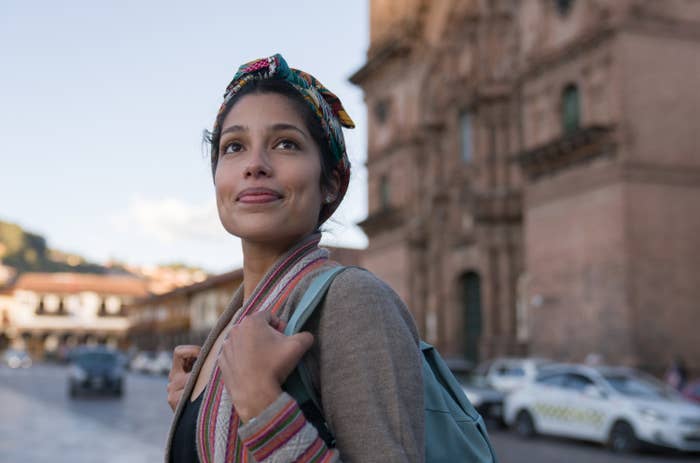 Woman looking up with a backpack on