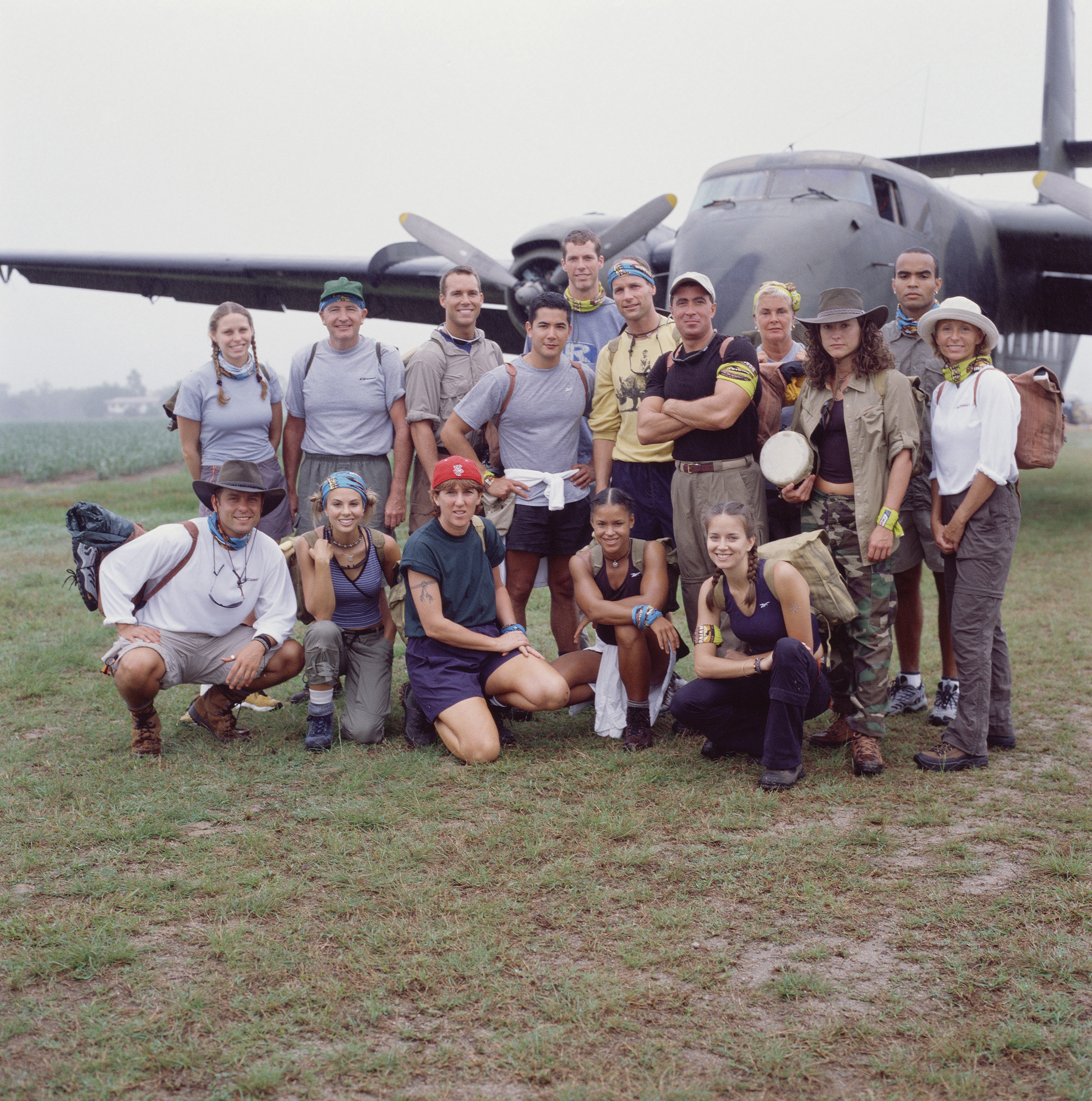 The Castaways stand in front of an airplane