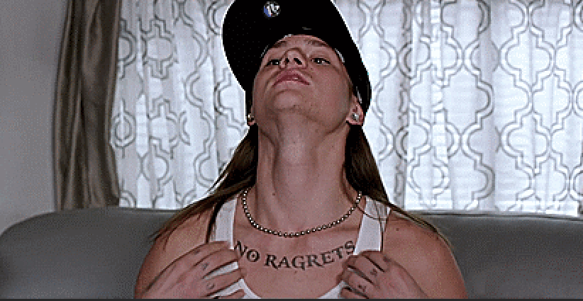 A person wearing a cap and showing a &quot;No ragrets&quot; tattoo below their neck
