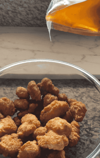 Pouring sauce on fried chicken