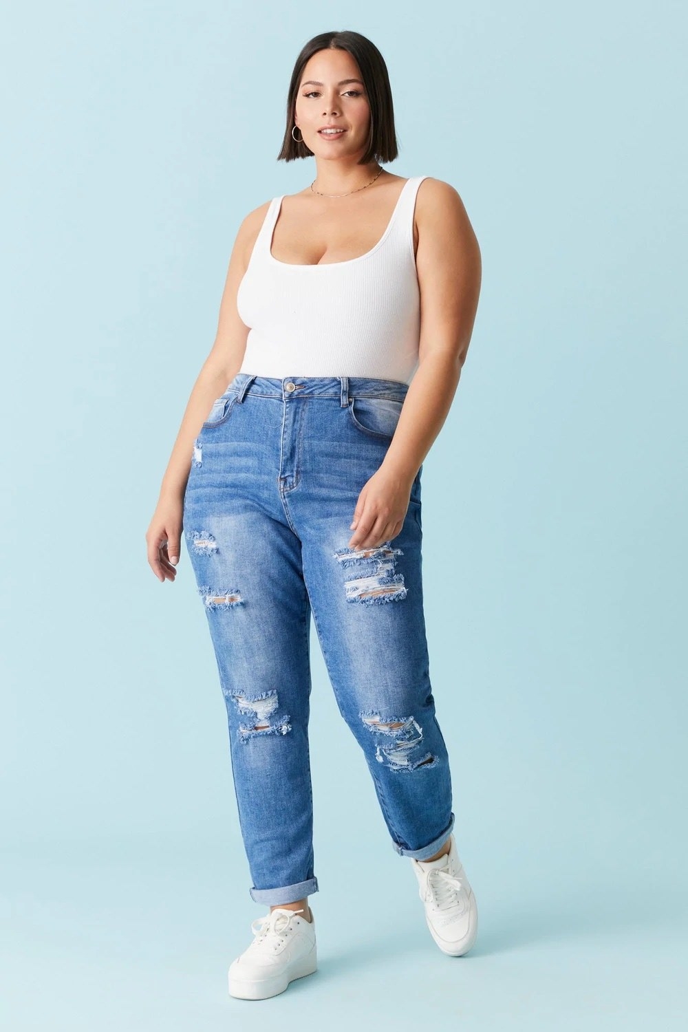model wearing distressed jeans