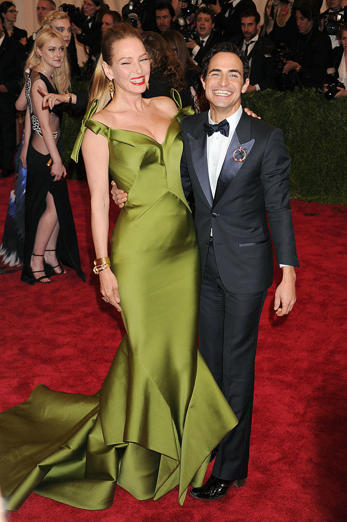 Uma in a shiny green dress and Zac in a black suit