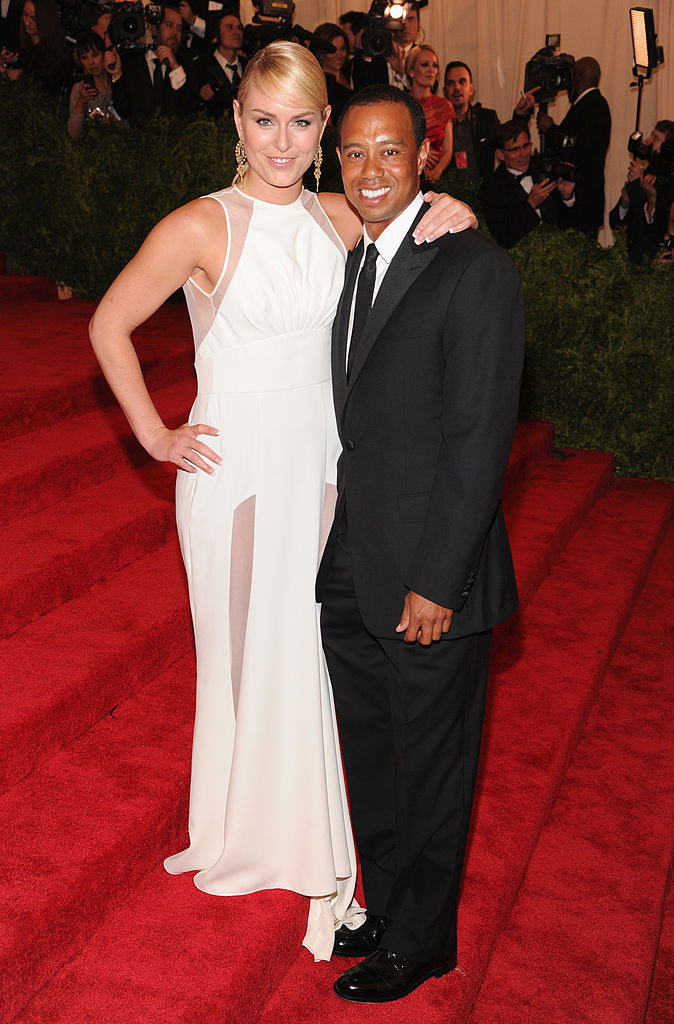 Lindsay wearing a white dress and Tiger wearing a simple black suit