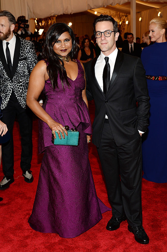 Mindy wearing a paisley dress and B.J. wearing a black suit