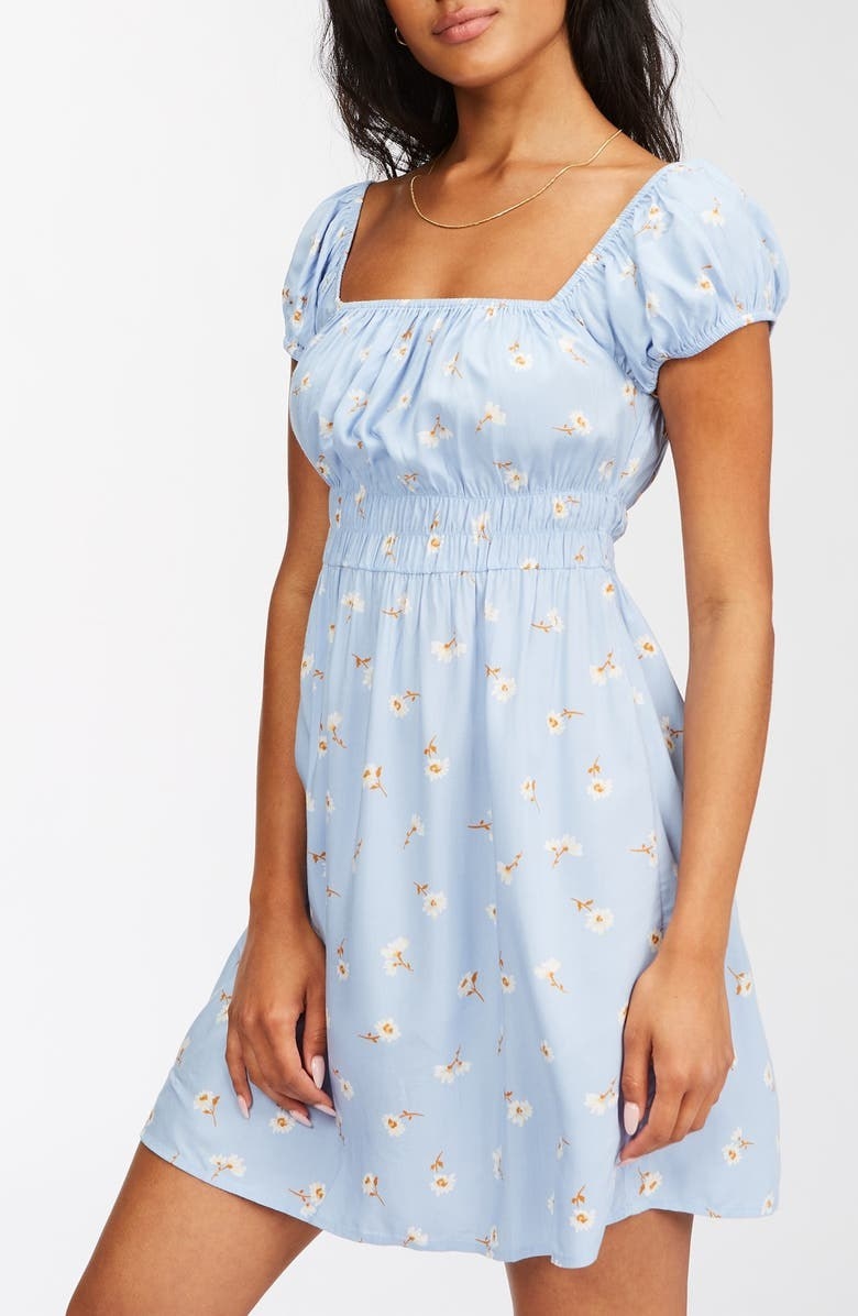 model in a light blue empire waist dress with flower pattern