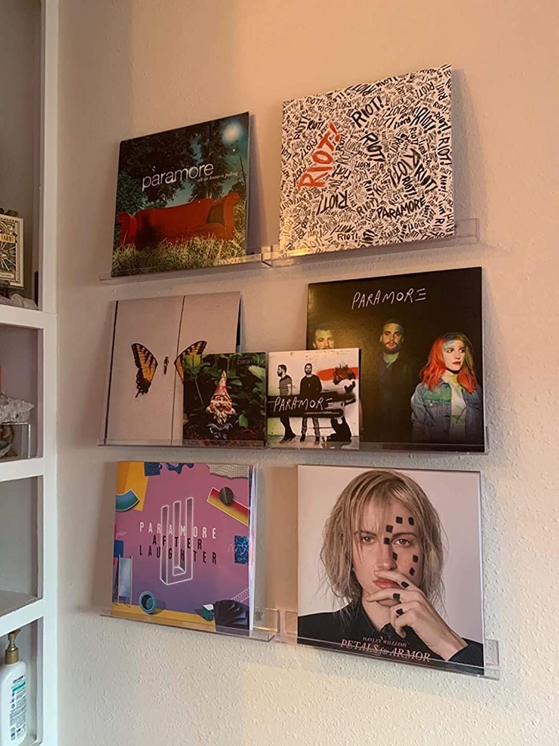 The shelves on a wall displaying a selection of Paramore albums