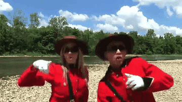 Man and Woman dressed as mounties dancing around Canada