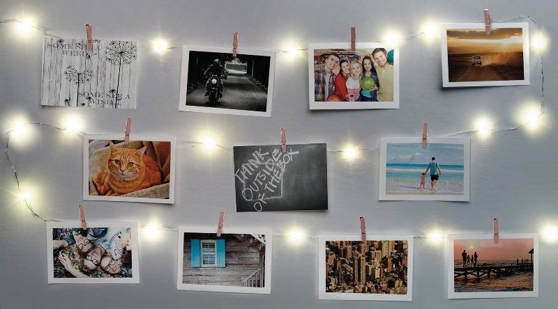 The string lights with photos hanging from the clips