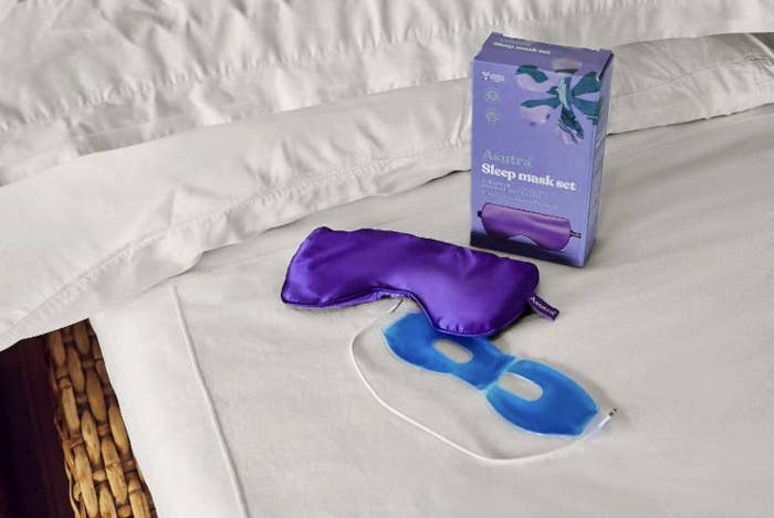 the purple silk eye mask with cooling gel insert separated and spread out on bed