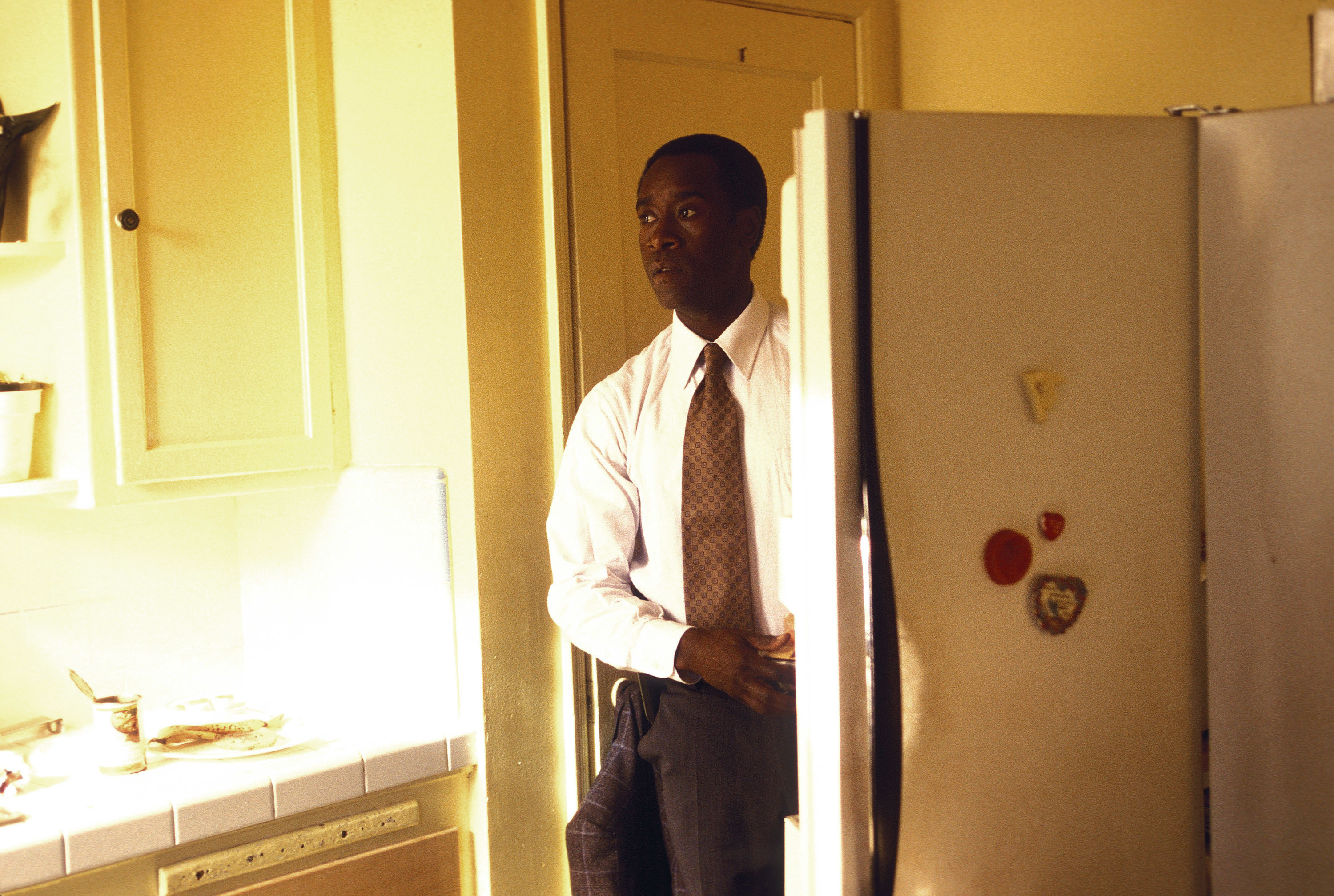 a man standing by an open fridge