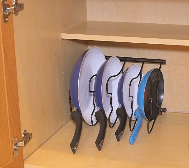 The organizer in a cupboard with frying pans