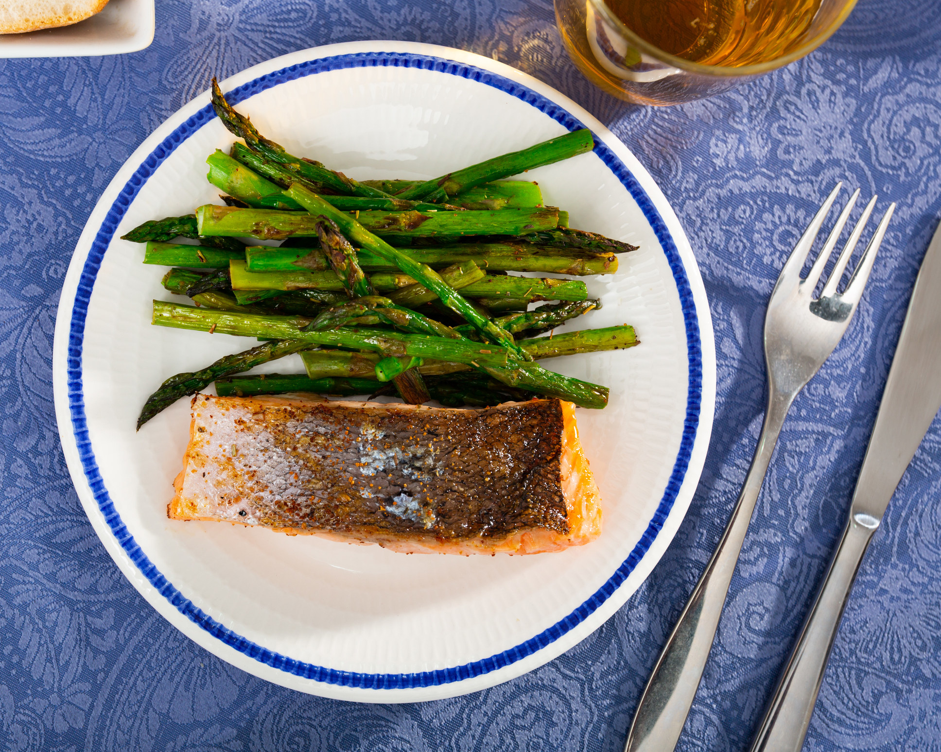 A piece of salmon with a side of asparagus