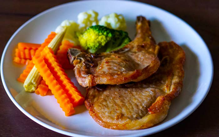 Two pork chops with boiled veggies