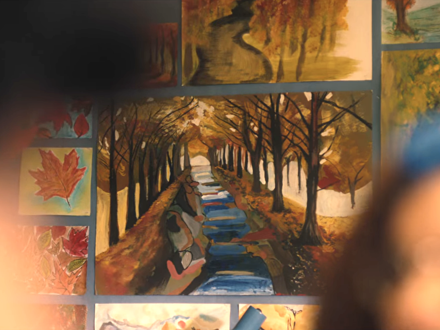 River lined with trees in a painting