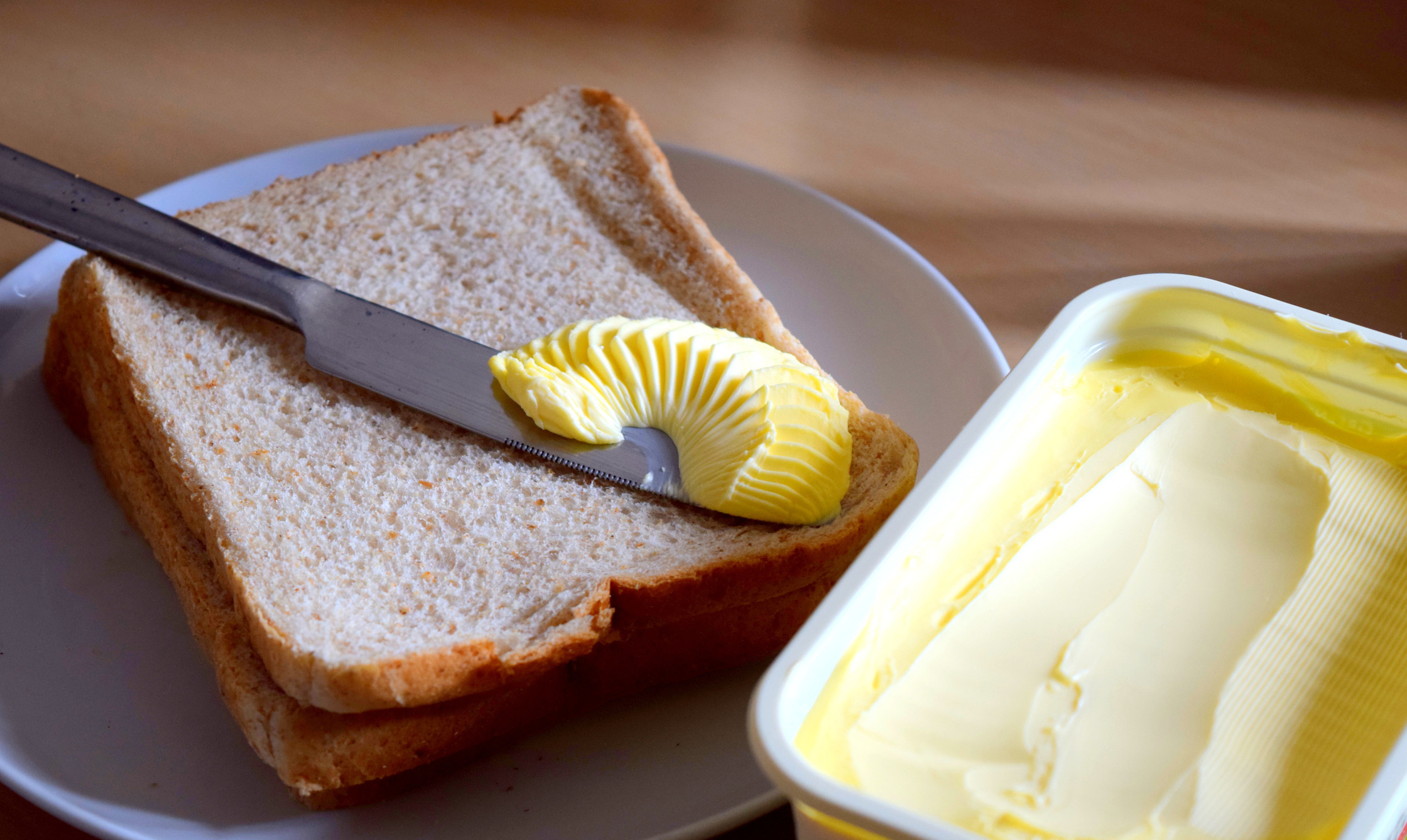 Spreading margarine butter onto bread