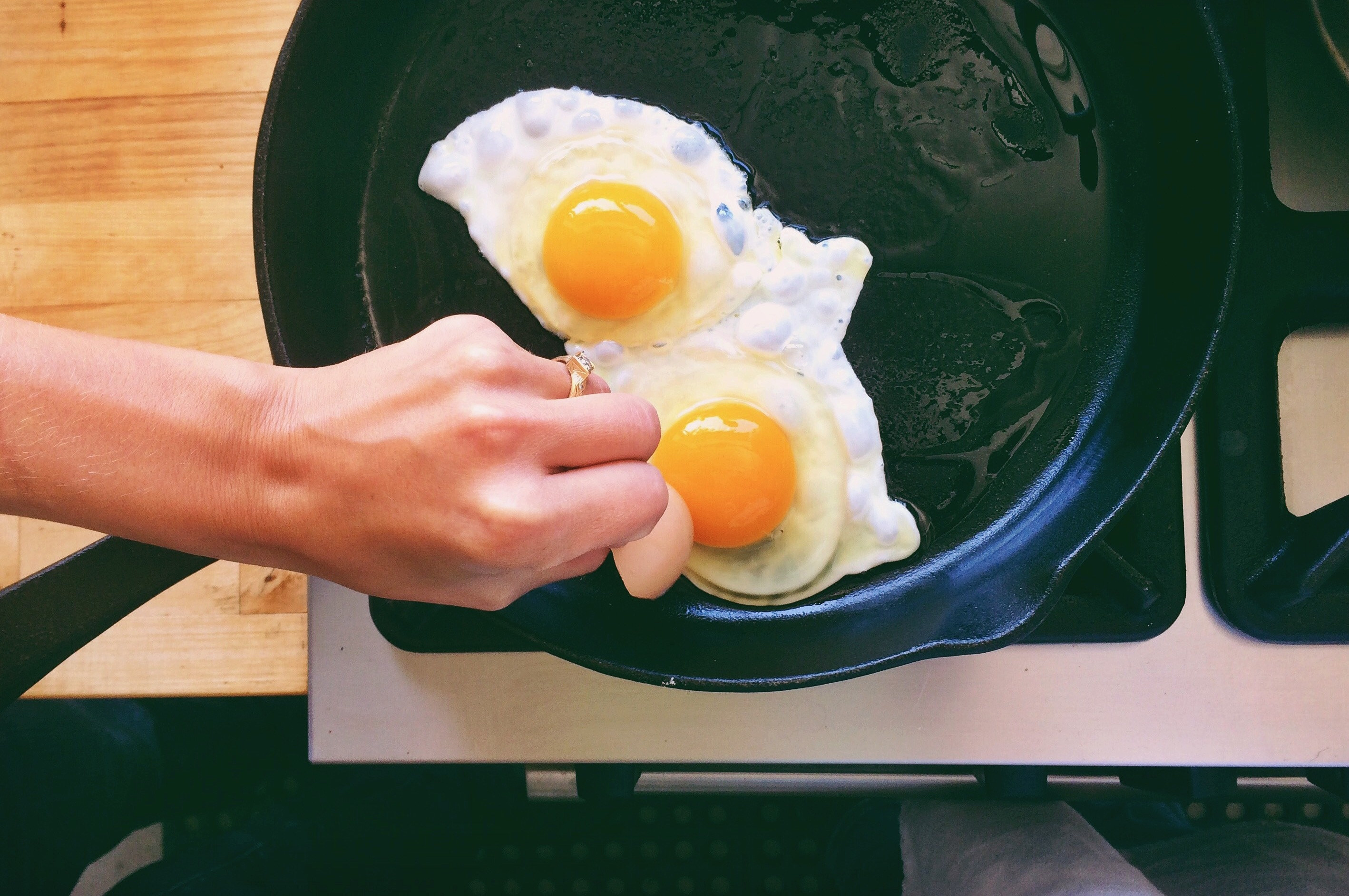 Frying eggs in a skillet.