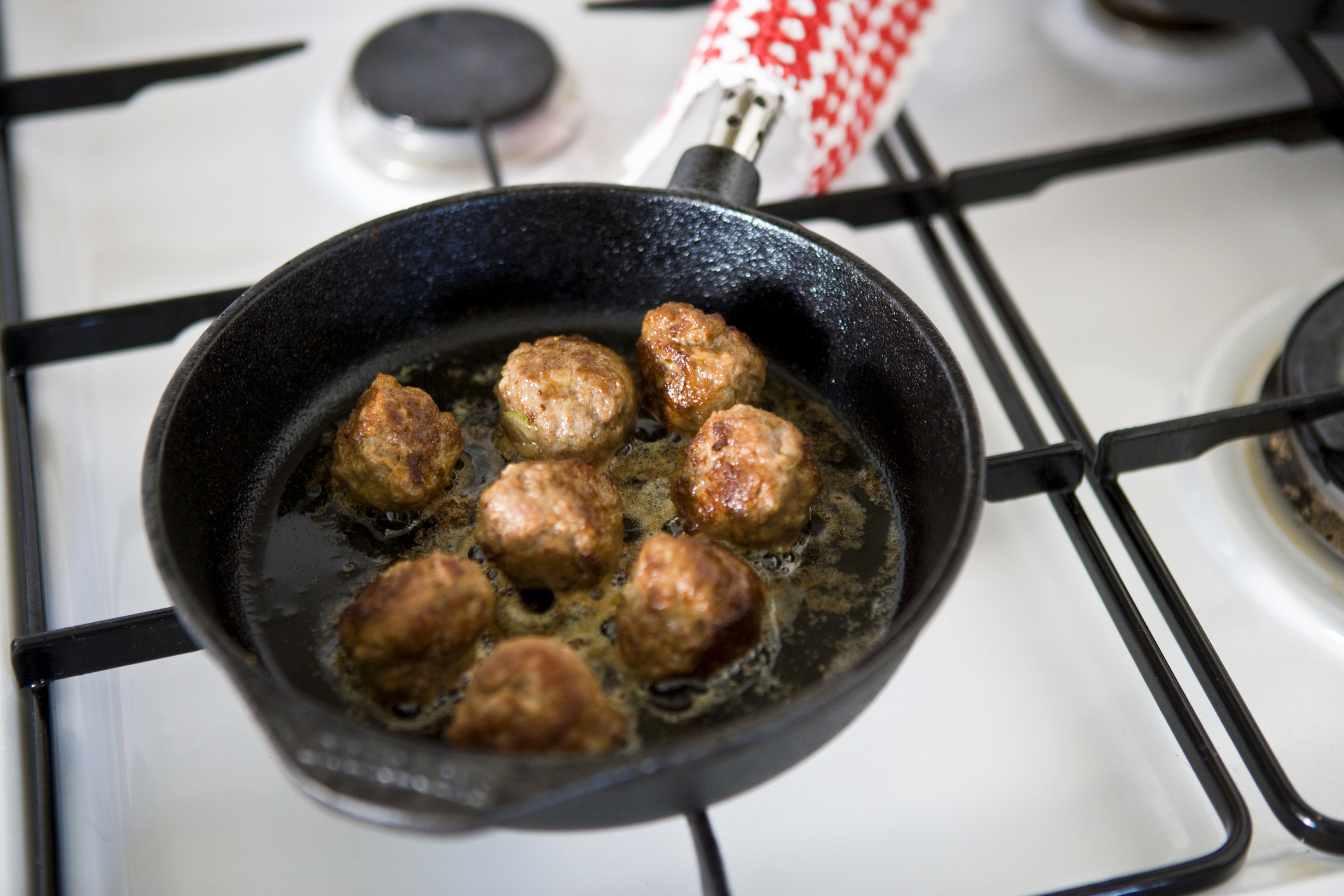 Meatballs cooking in a skillet