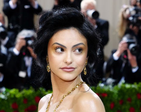 Camila Mendes wearing an updo and gold earrings
