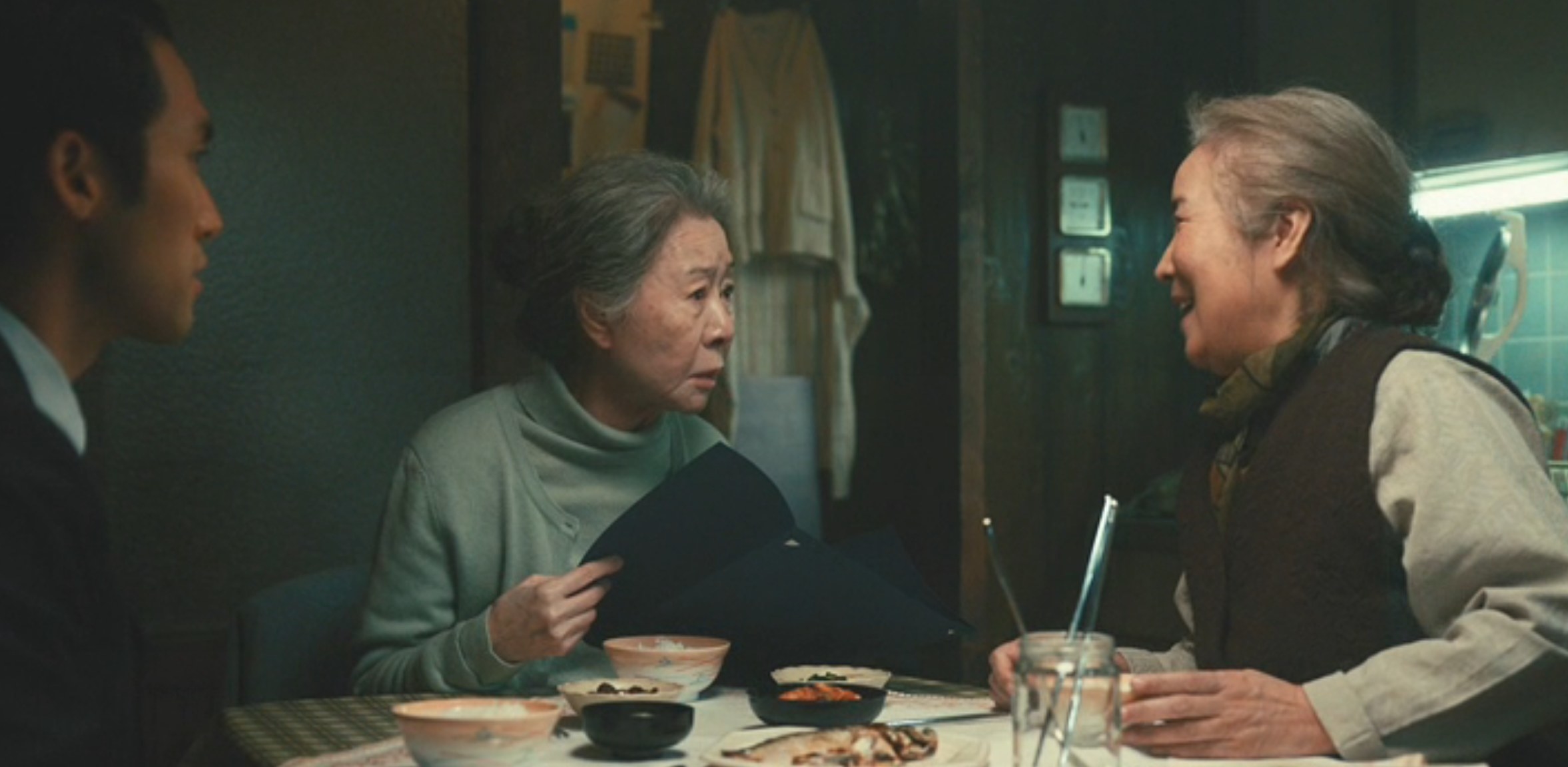 Older Sunja and Solomon having dinner with older Asian lady