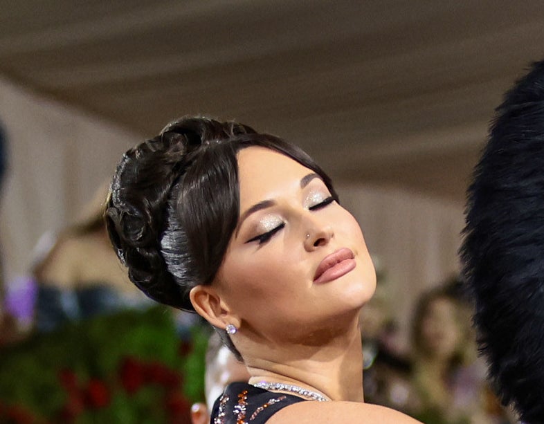 Kacey Musgraves closing her eyes to reveal sparkly eyeshadow