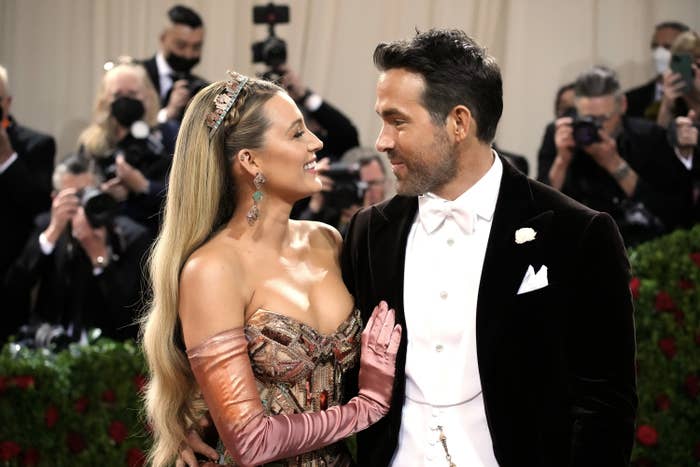 Blake Lively and Ryan Reynolds look at each other and smile