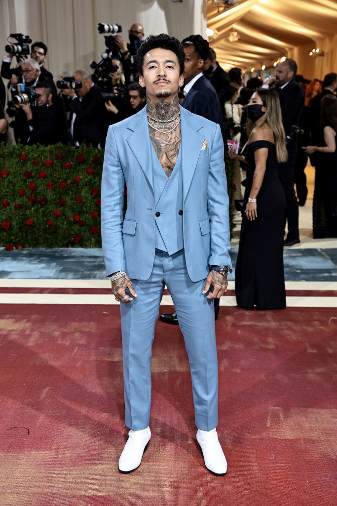 Nyjah Huston in a powder blue suit and vest without a shirt