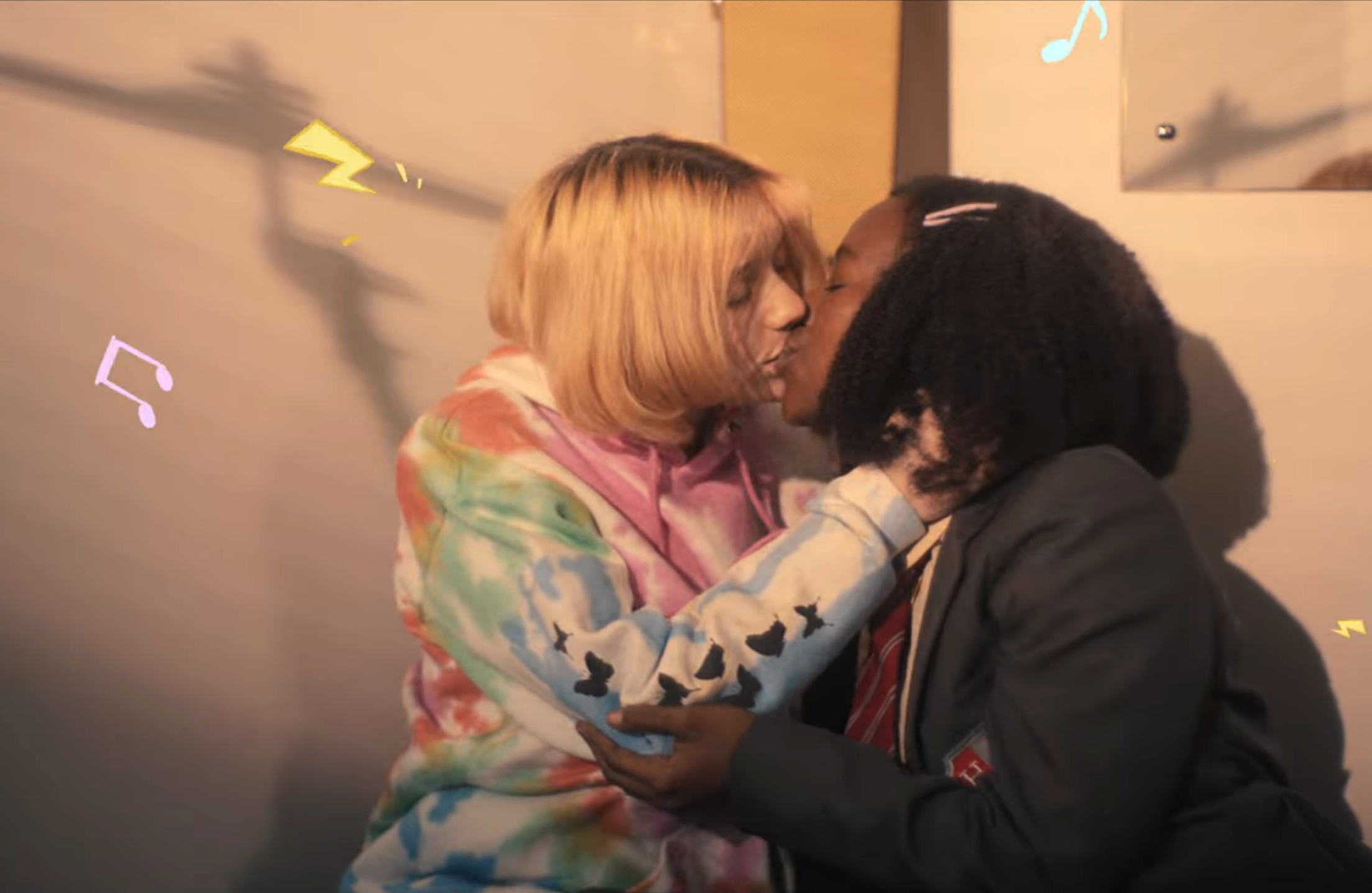 Sparks and music notes around Darcy and Tara kissing