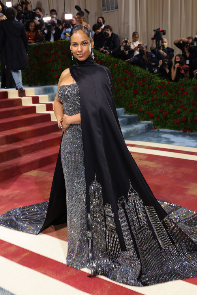 Alicia Keys in a gown with a cityscape on its train