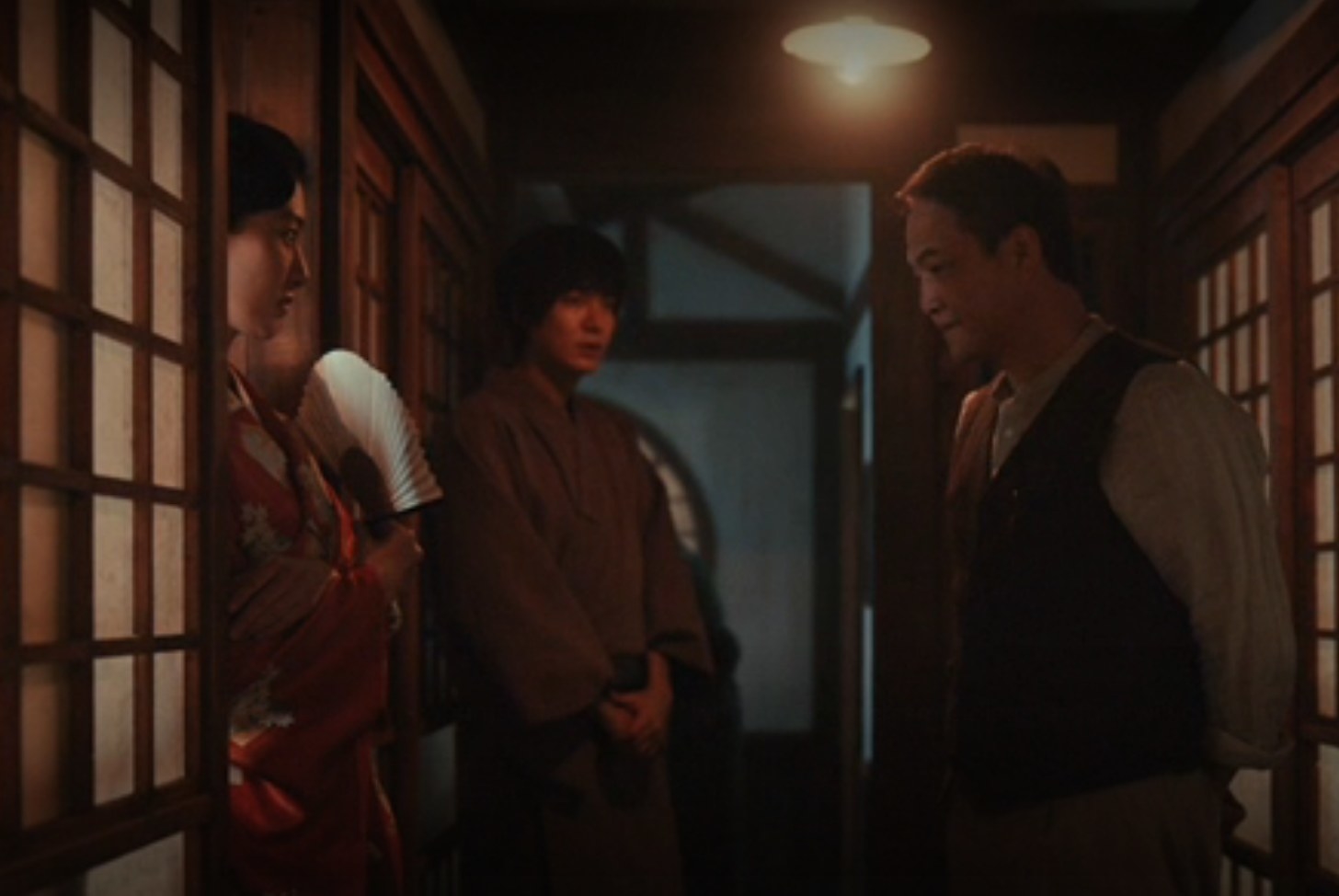 Hansu standing by as his father asks for his money back from a prostitute