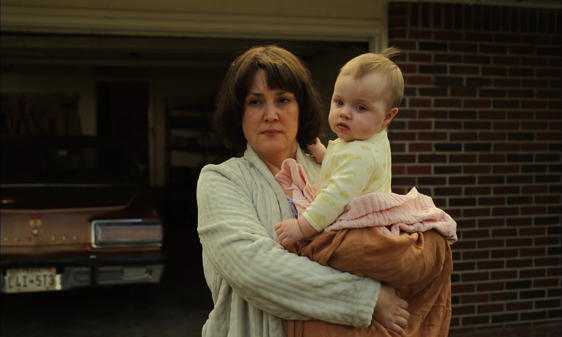 Melanie Lynskey with a baby in her arms