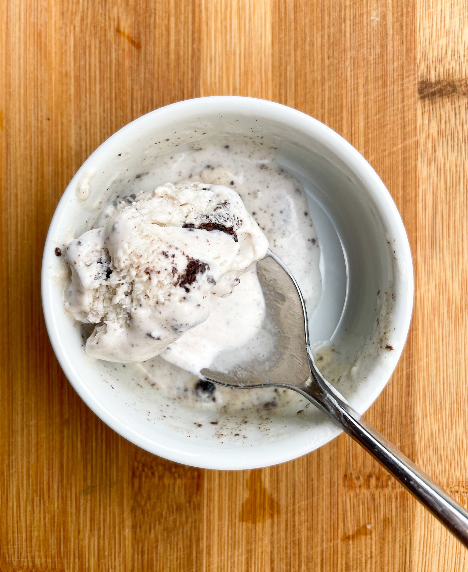 A pint of ice cream with a spoon in it