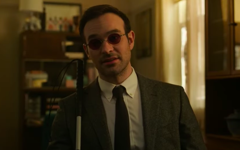 Charlie as Matt in a suit, tie, and sunglasses