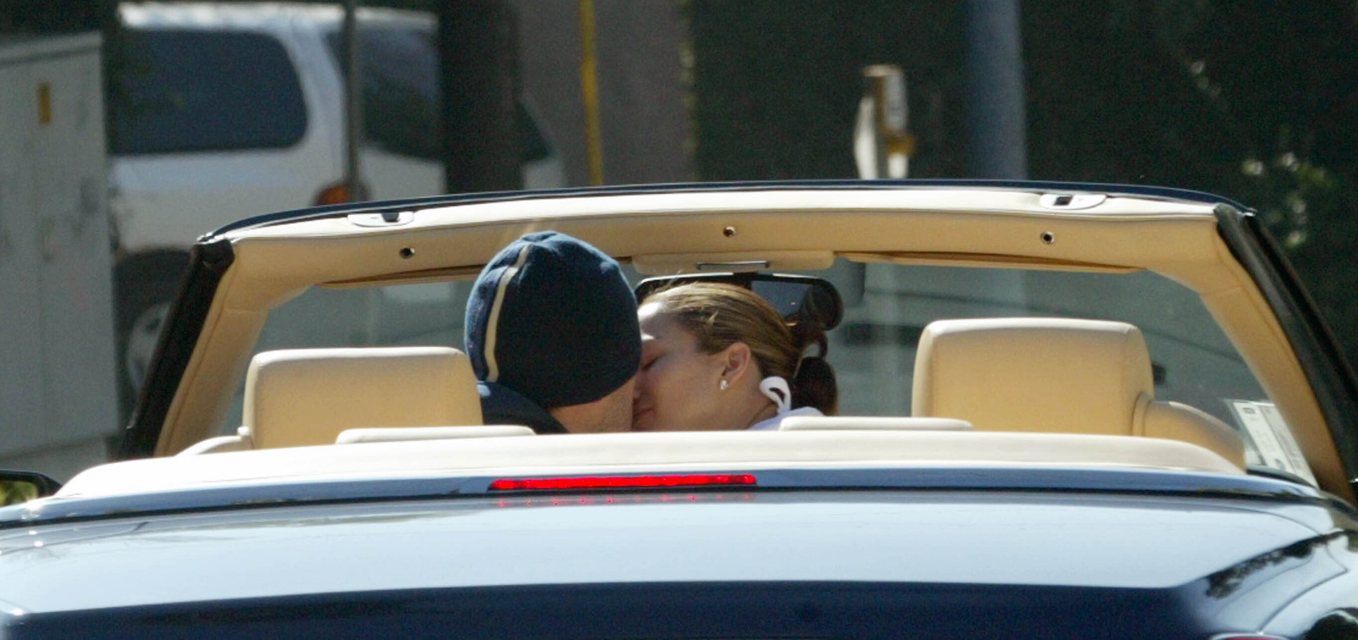 Ben and Jen kissing in a car
