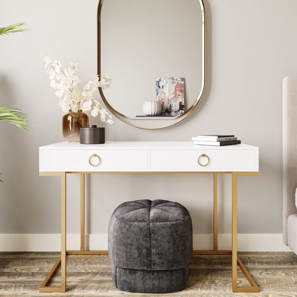 the white vanity table with gold legs