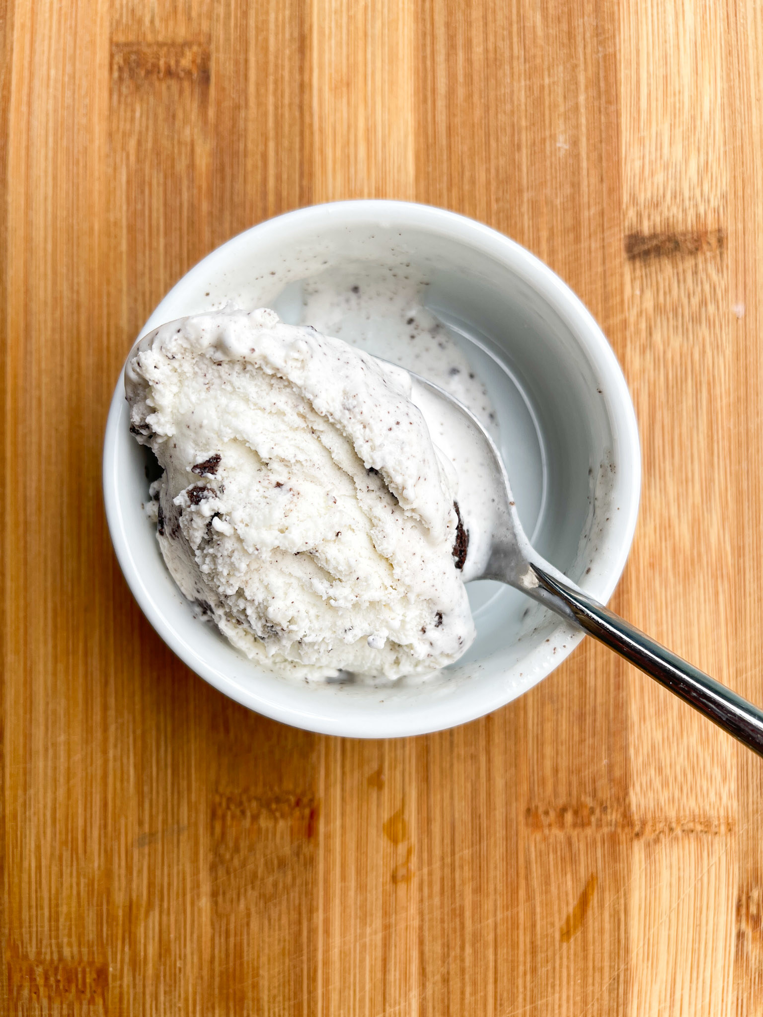 A pint of ice cream with a spoon in it