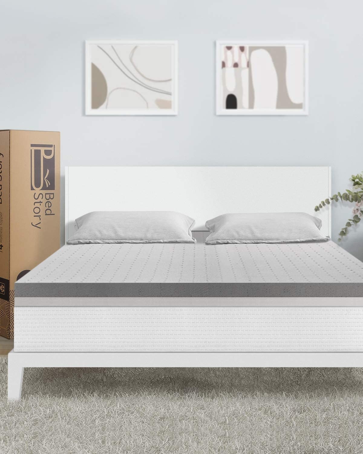 A bed with a mattress topper and pillows on it