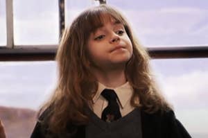 Hermione staring ahead smugly on the Hogwarts Express in Harry Potter and the Sorcerer's Stone