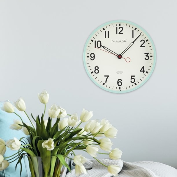 the retro-looking wall clock with light blue bordering
