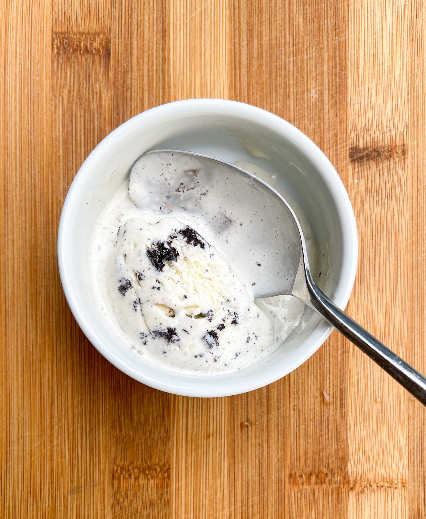 A pint of ice cream with a spoon in it