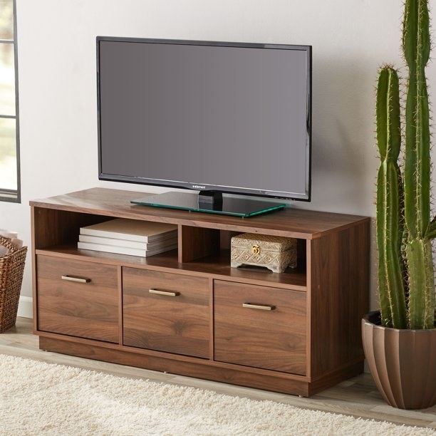 the TV stand with three pull-out drawers
