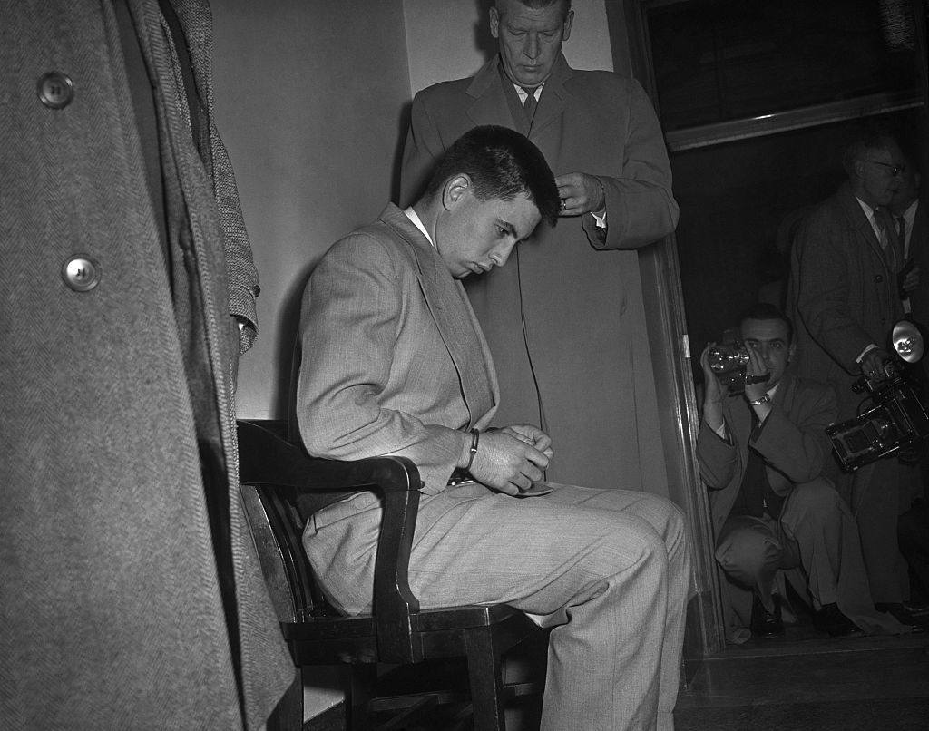 A handcuffed man in a chair