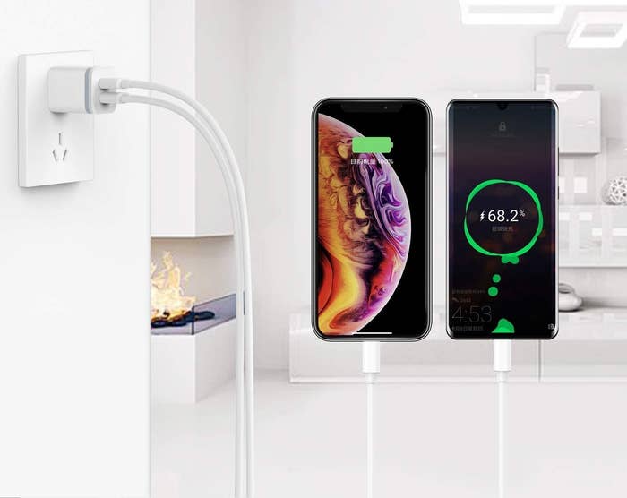 the charging block plugged into a wall with phones plugged in