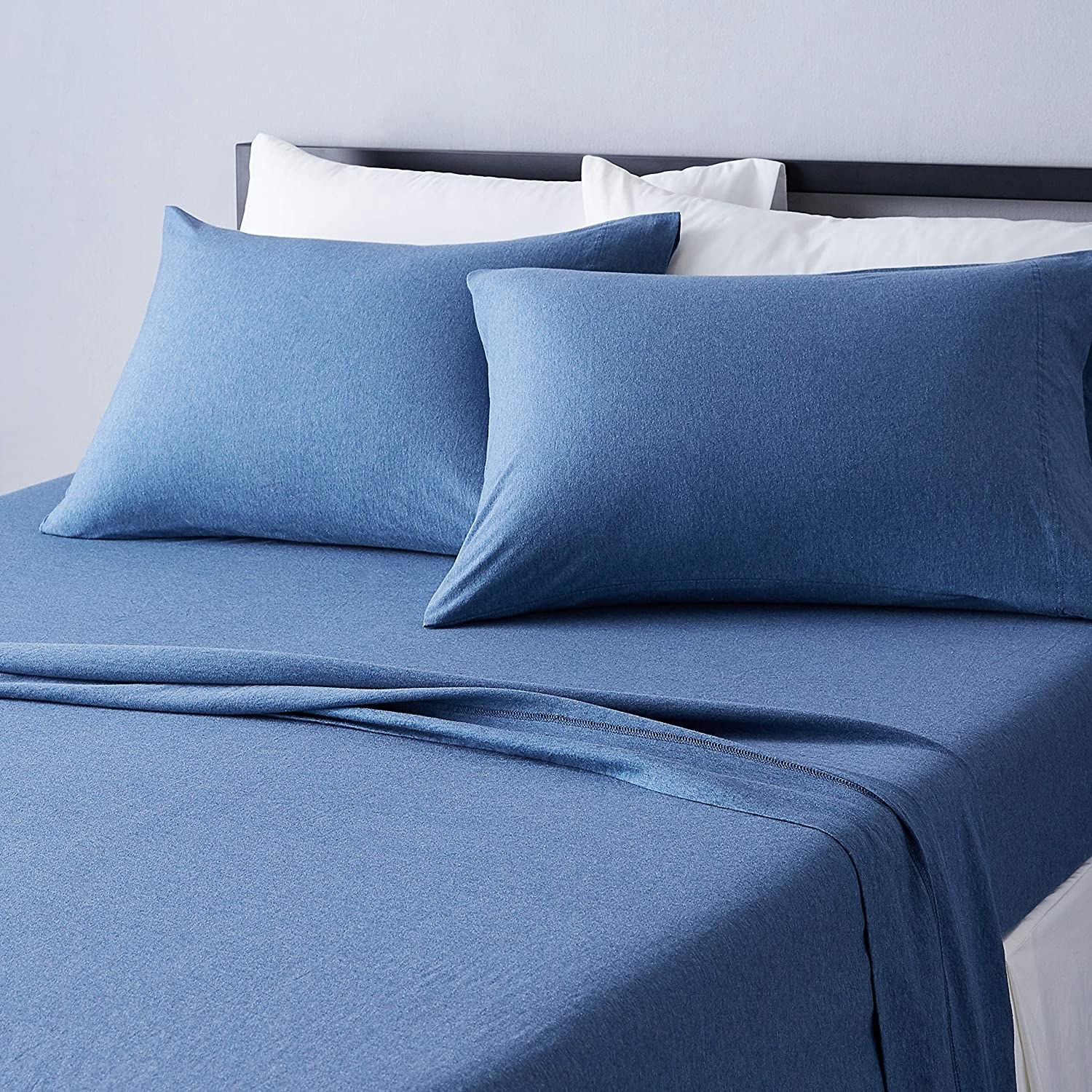 a chambray sheet set on a neatly made up bed