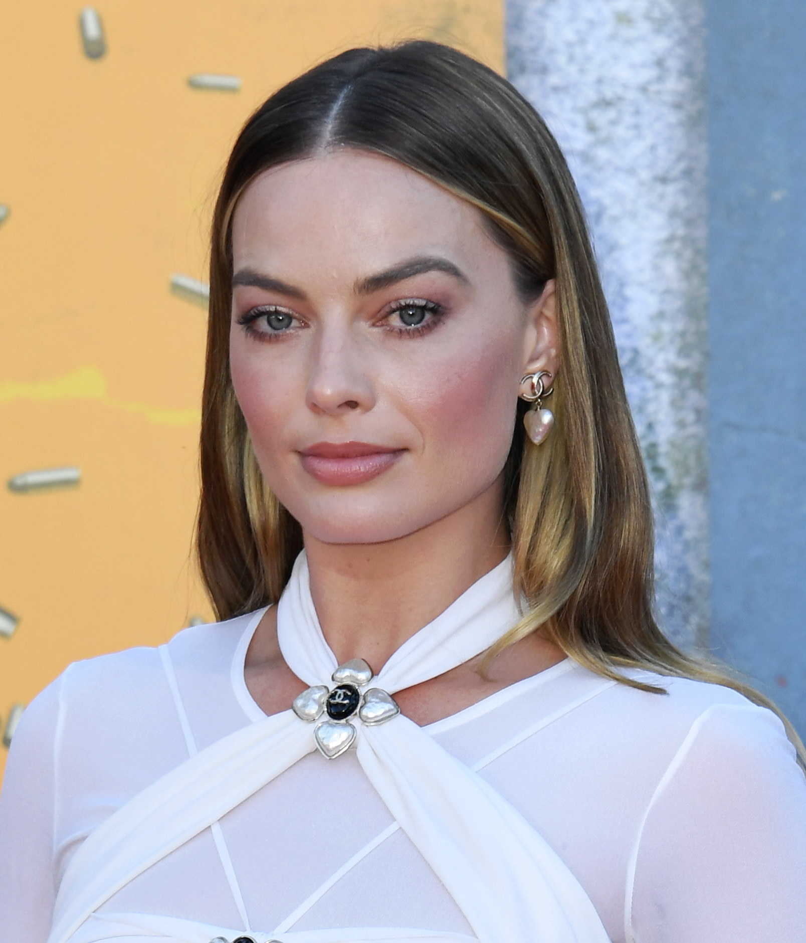 Margot in a white outfit at a red carpet event