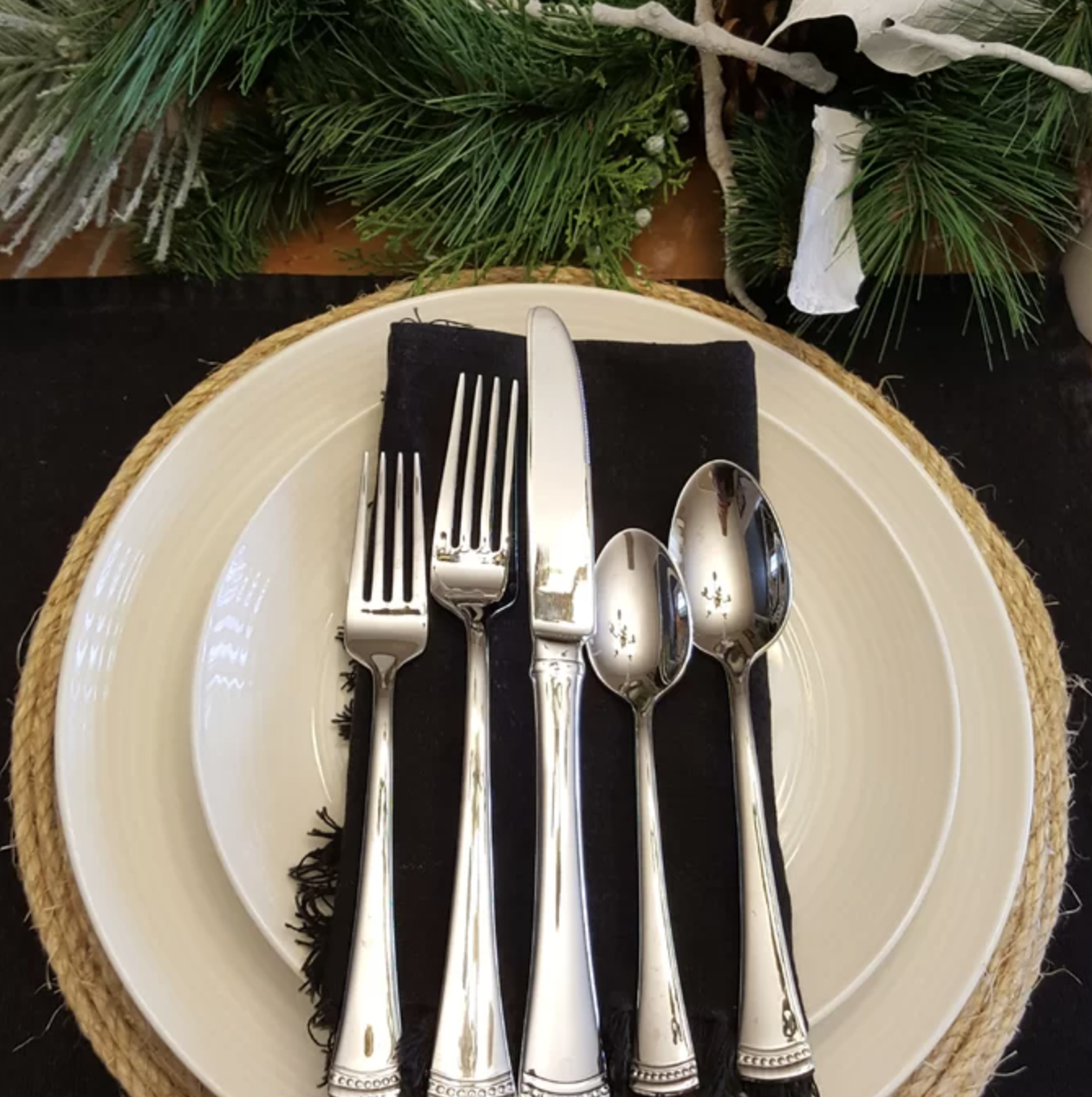 stainless steel forks, spoons, and knife on a plate