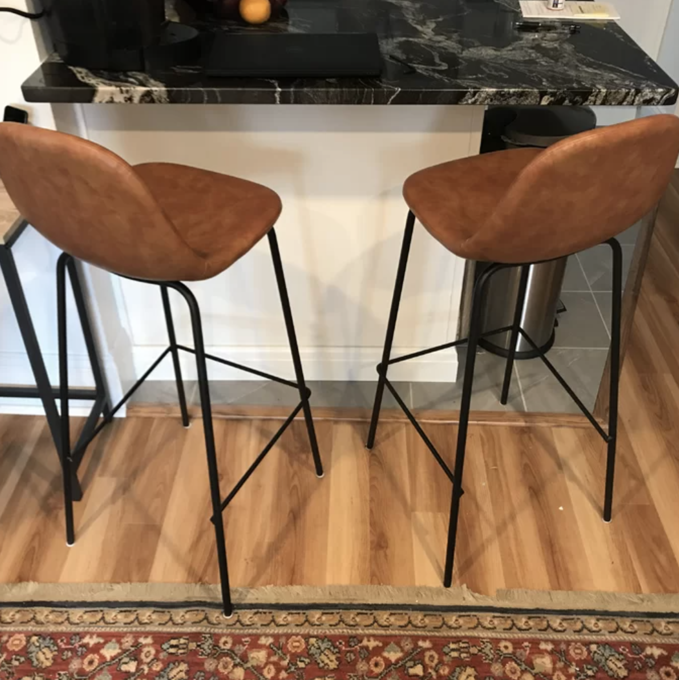 two bar stools in tan at a counter