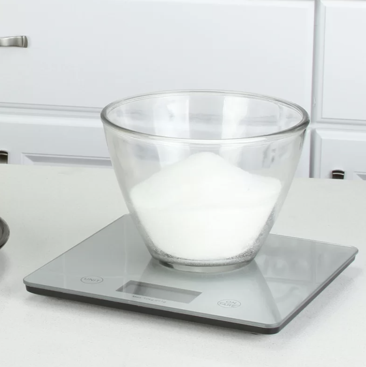 a digital scale weighing a cup of sugar