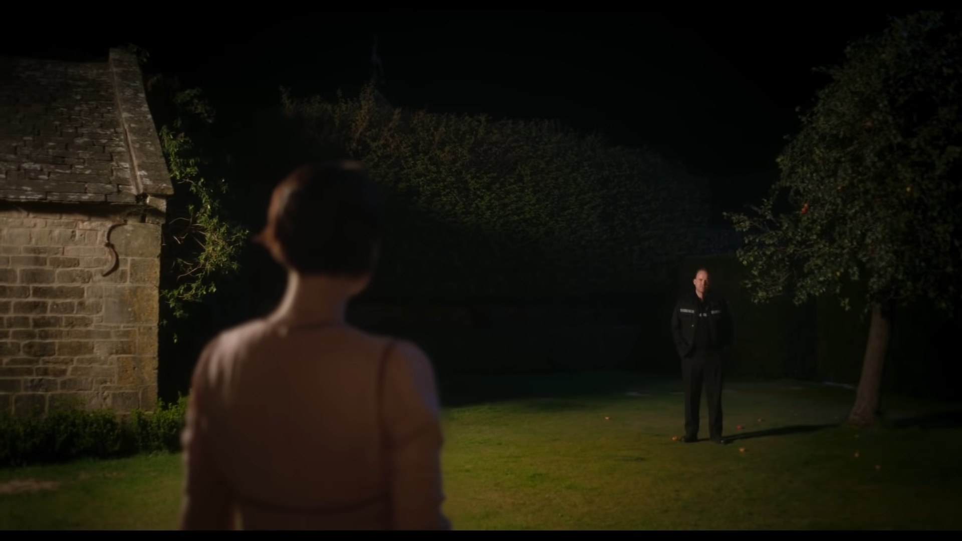 Harper looking at a police officer on her lawn in &quot;Men&quot;