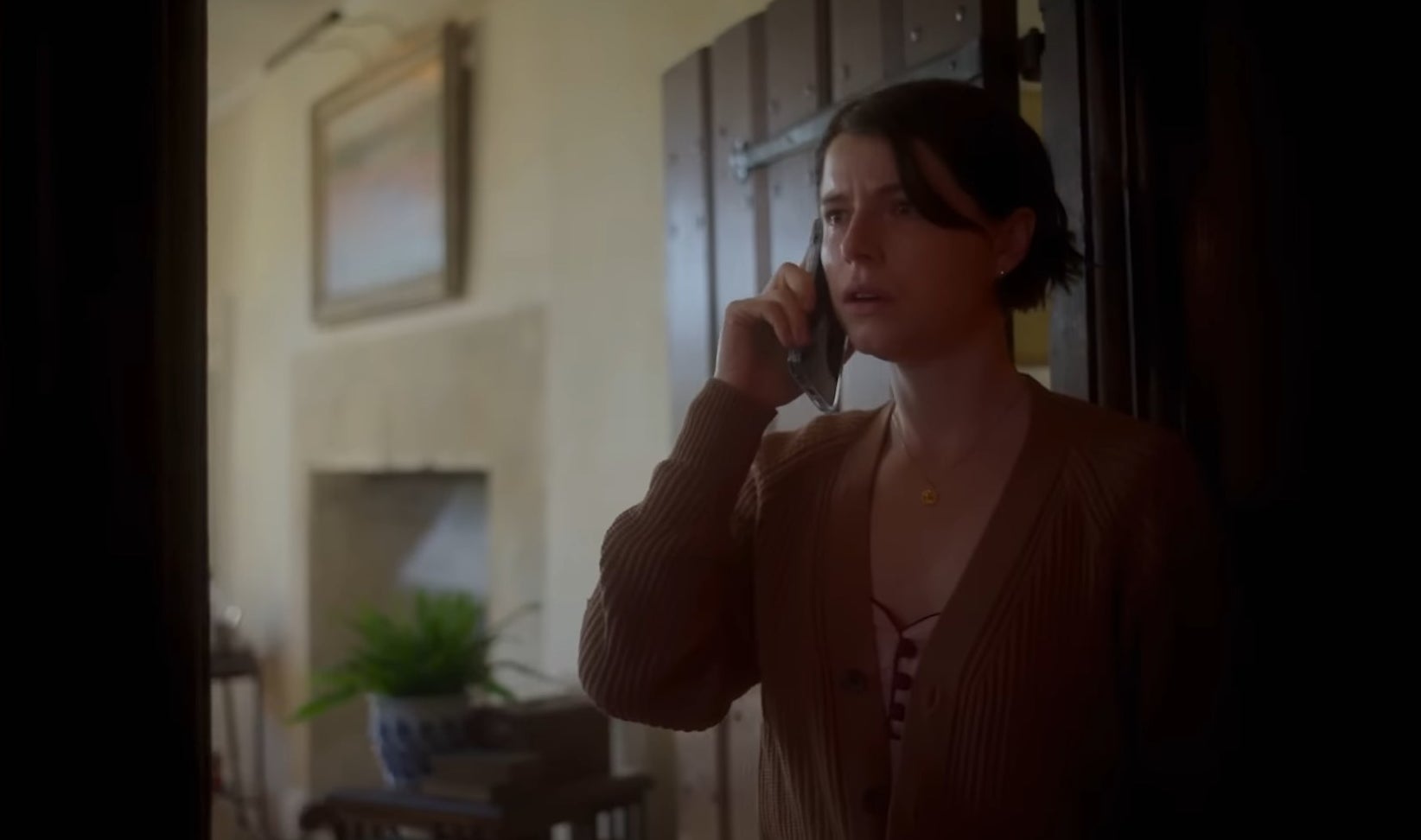 Harper holding a phone to her ear in "Men"