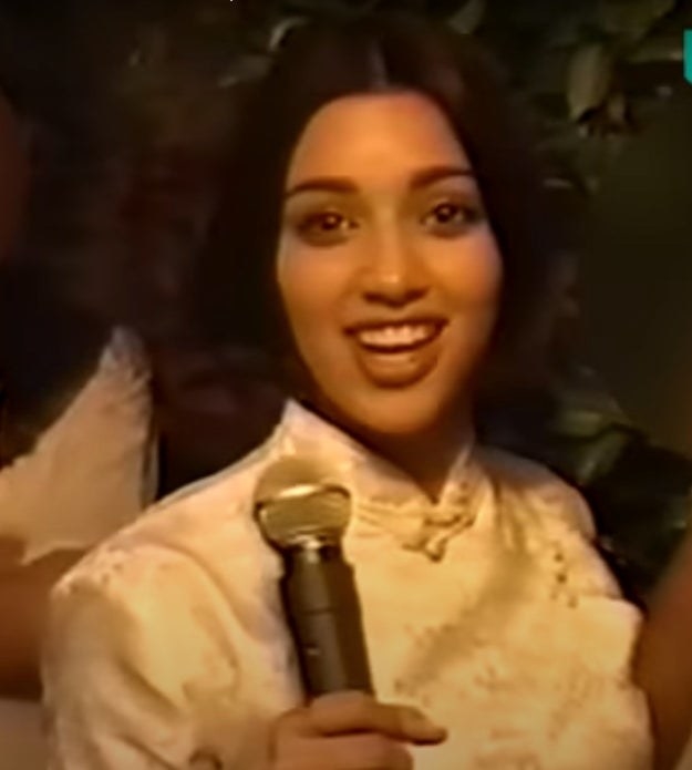 Kim Kardashian speaks into the microphone at a 1994 graduation party